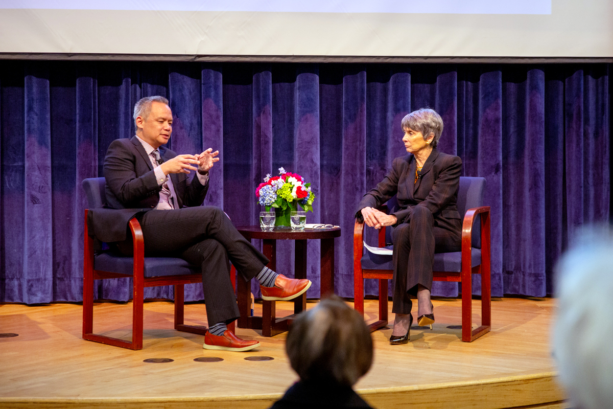 Edward Wong and Amb. Bodine having a conversation on stage