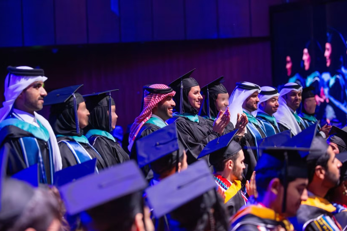 EMDIA graduation ceremony, students in regalia celebrating