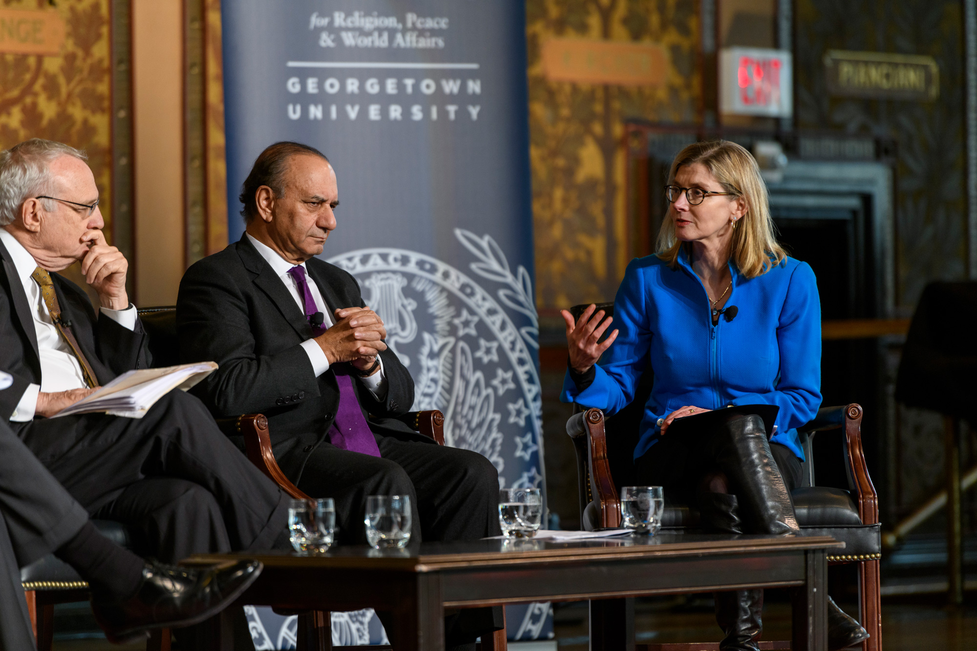 Three people having a conversation on stage