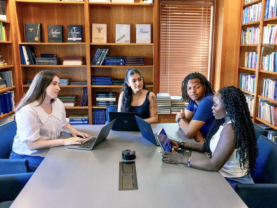 Four students having a conversation sitting around a table